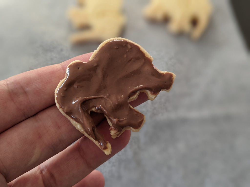 spread chocolate on animal biscuit